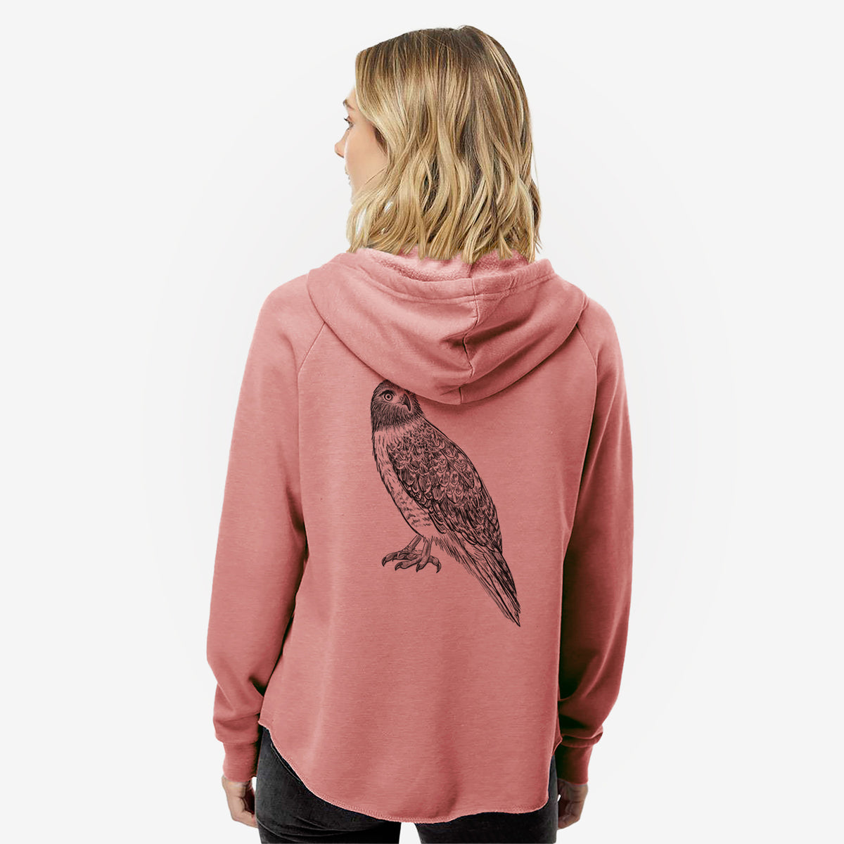 Woman wearing a dusty rose women's Cali Wave zip-up sweatshirt printed with a detailed black ink illustration of a red-tailed hawk perched, seen from behind.