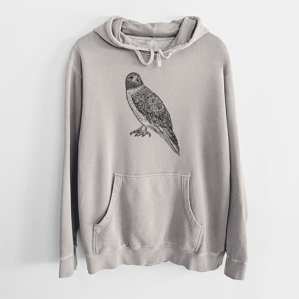Cement grey pigment dyed hoodie laid flat, printed with a detailed black ink illustration of a red-tailed hawk perched.
