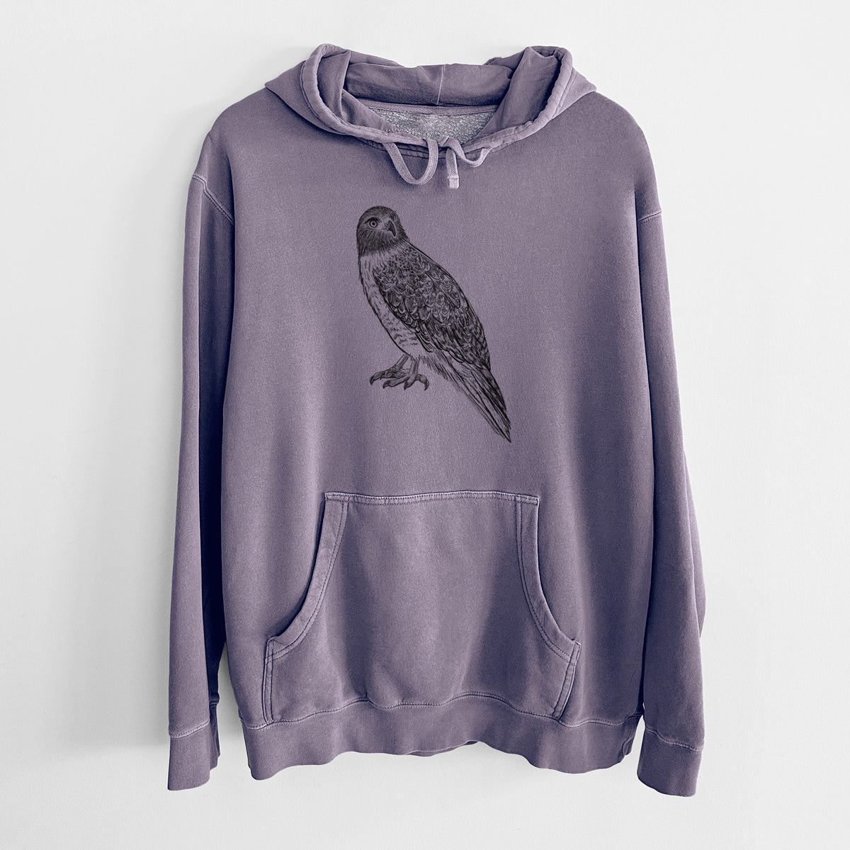 Plum purple pigment dyed hoodie laid flat, printed with a detailed black ink illustration of a red-tailed hawk perched.