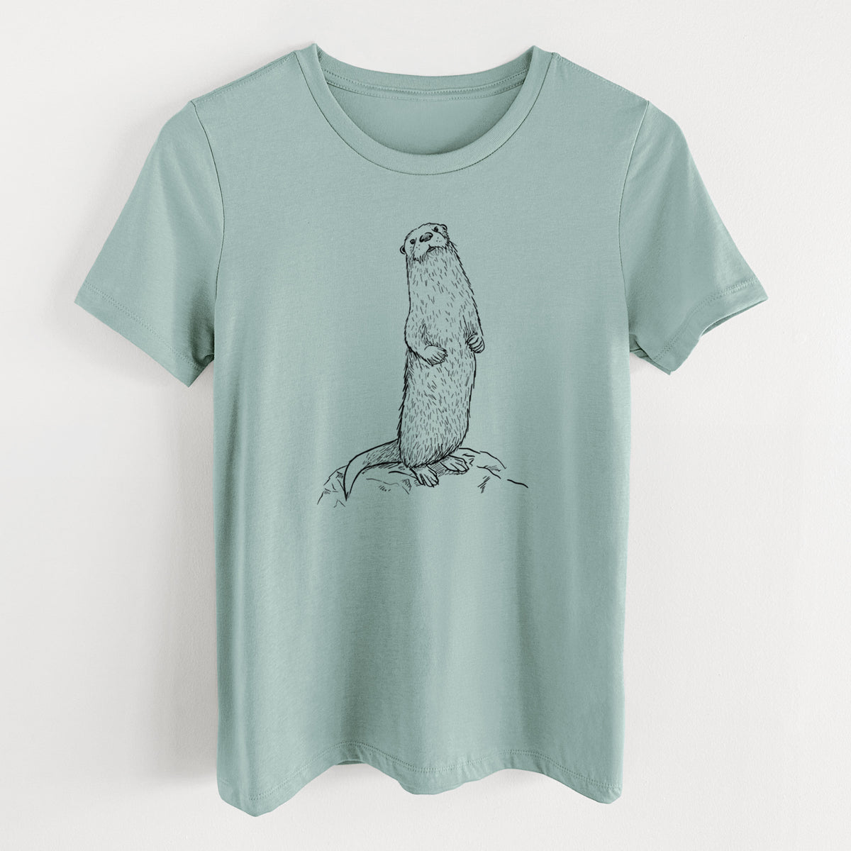 Dusty blue women's relaxed fit cotton t-shirt laid flat, printed with a black ink illustration of a river otter standing upright on a rock.