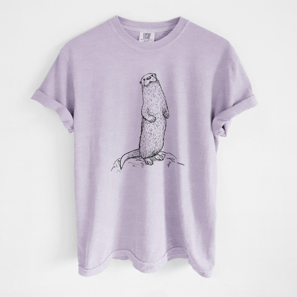 Orchid purple Comfort Colors t-shirt laid flat, printed with a black ink illustration of a river otter standing upright on a rock.