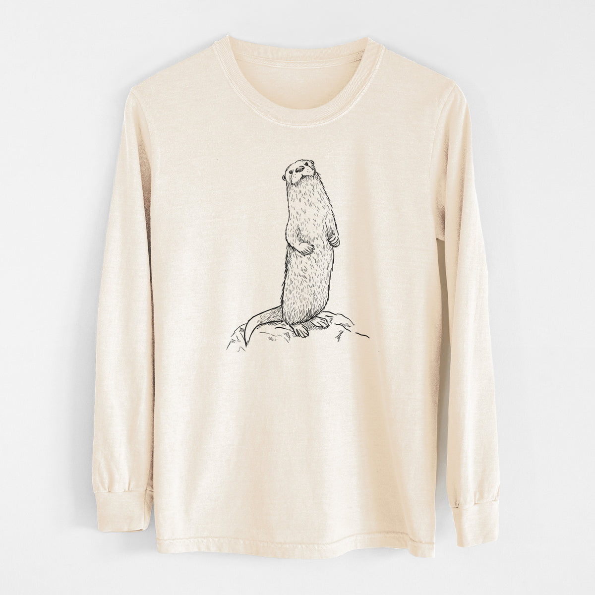 Ivory Comfort Colors long sleeve shirt laid flat, printed with a black ink illustration of a river otter standing upright on a rock.