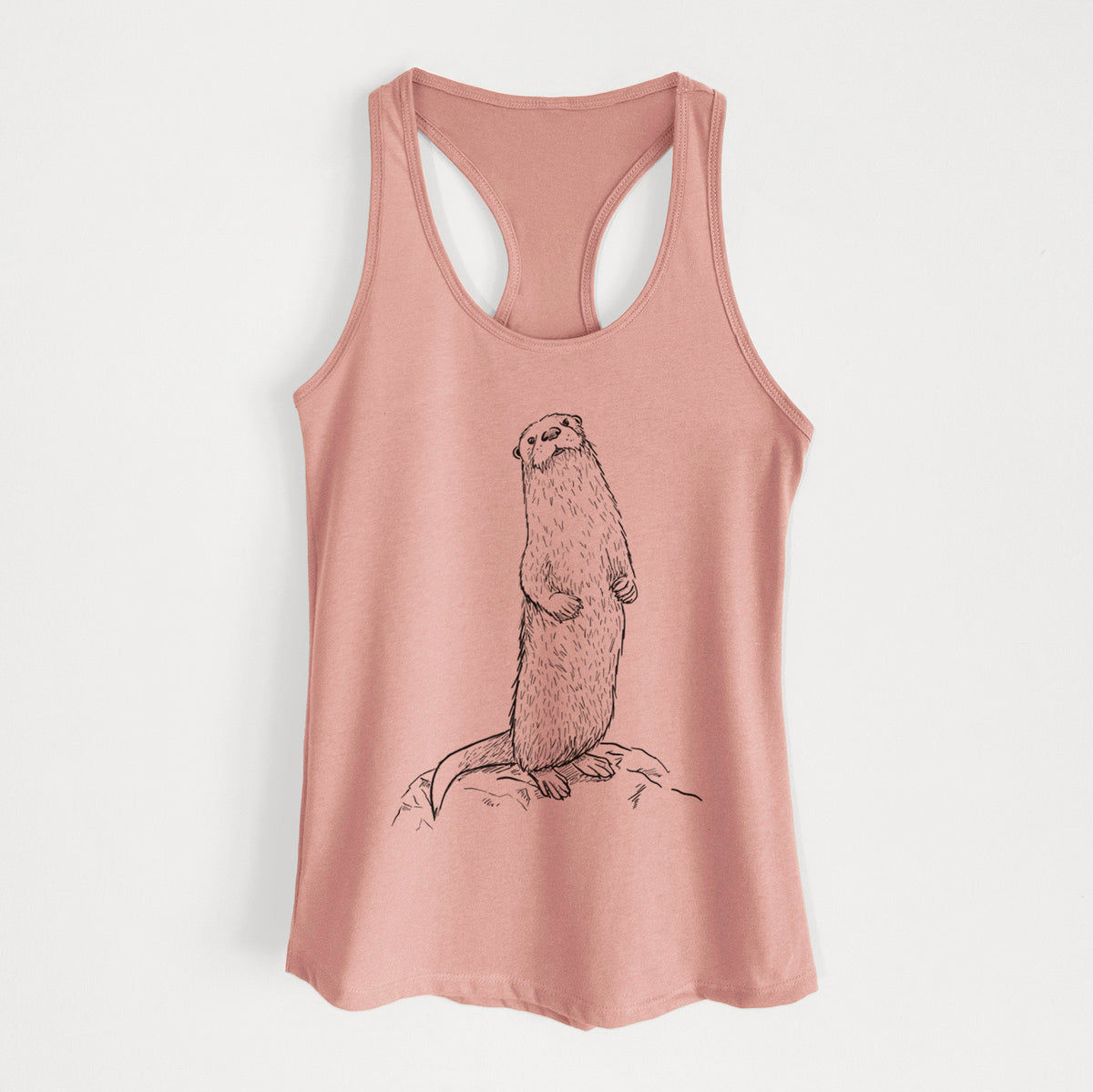 Desert pink women's racerback tank top laid flat, printed with a black ink illustration of a river otter standing upright on a rock.