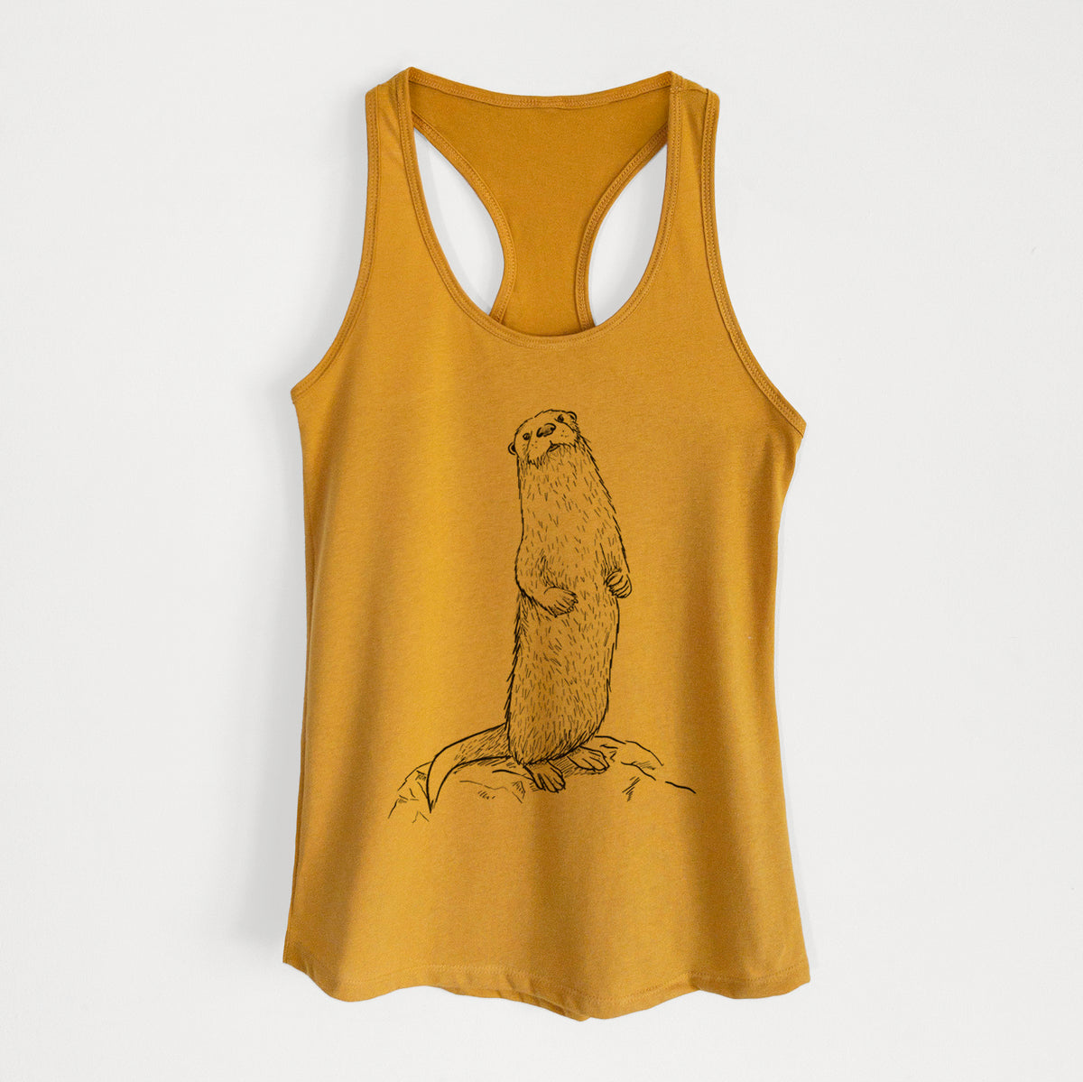 Gold women's racerback tank top laid flat, printed with a black ink illustration of a river otter standing upright on a rock.