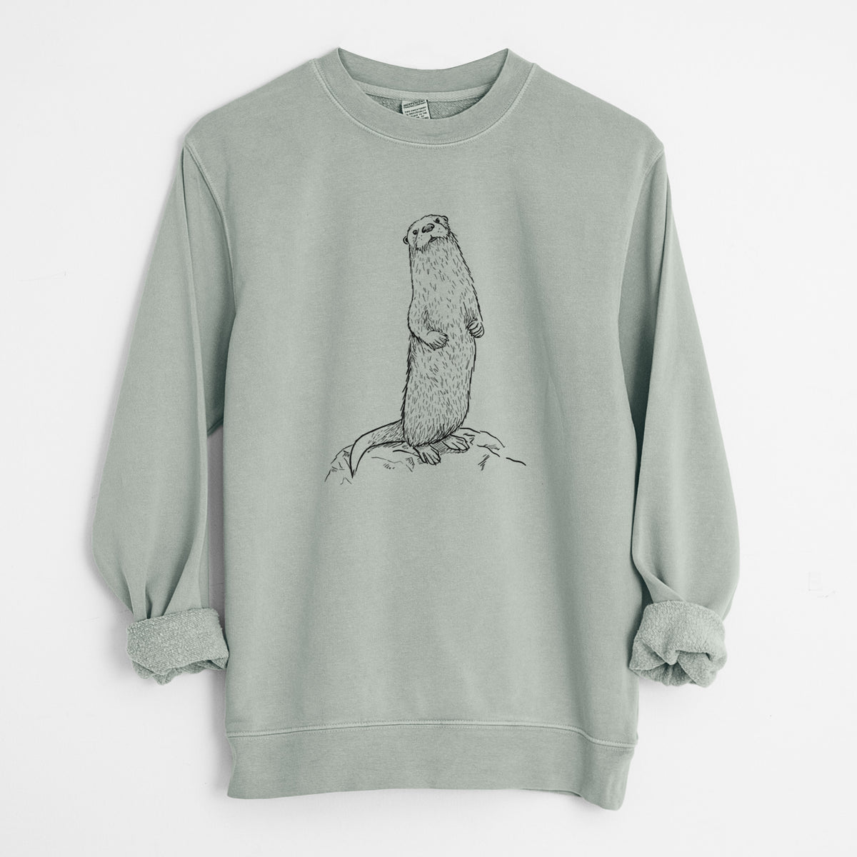 Sage green pigment dyed crewneck sweatshirt laid flat with the sleeves rolled, printed with a black ink illustration of a river otter standing upright on a rock.