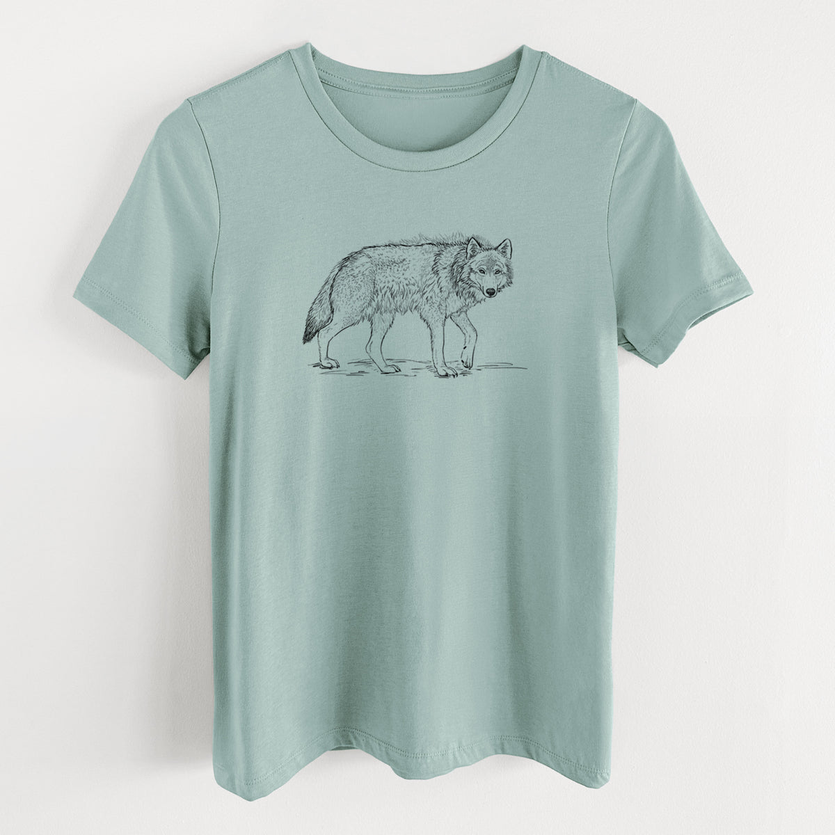 Dusty blue women's relaxed fit cotton t-shirt laid flat, printed with a detailed black ink illustration of a grey wolf walking.