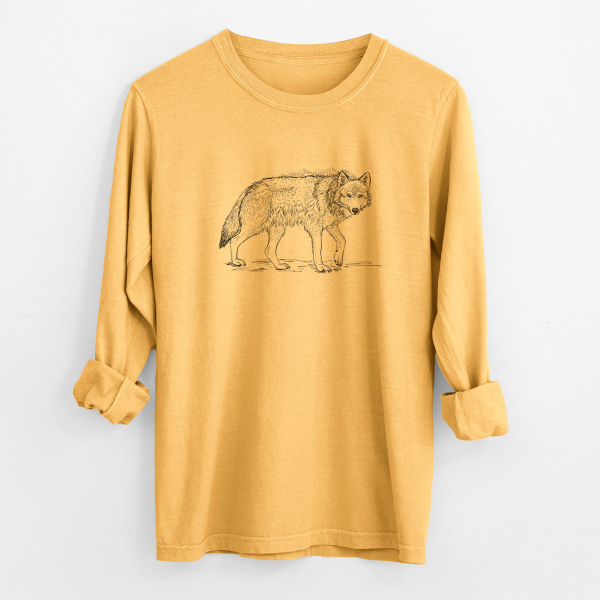 Golden wheat yellow Comfort Colors long sleeve shirt laid flat with the cuffs rolled, printed with a detailed black ink illustration of a grey wolf walking.