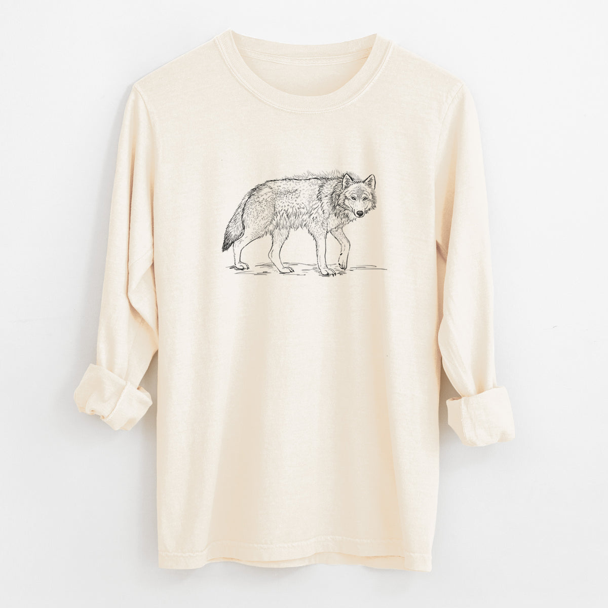 Ivory Comfort Colors long sleeve shirt laid flat with the cuffs rolled, printed with a detailed black ink illustration of a grey wolf walking.