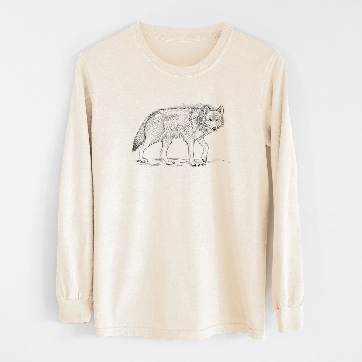 Ivory Comfort Colors long sleeve shirt laid flat, printed with a detailed black ink illustration of a grey wolf walking.