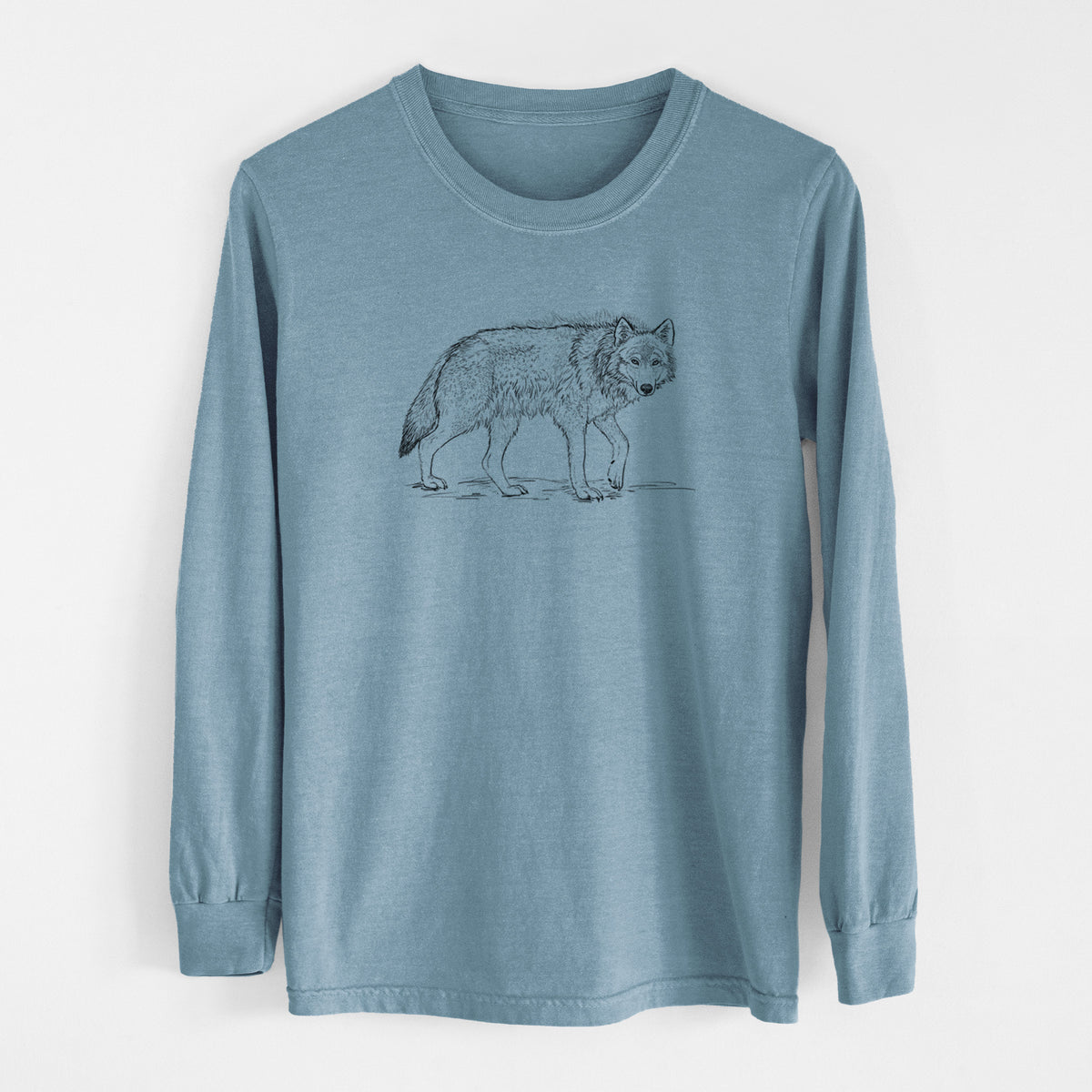 Steel blue Comfort Colors long sleeve shirt laid flat, printed with a detailed black ink illustration of a grey wolf walking.
