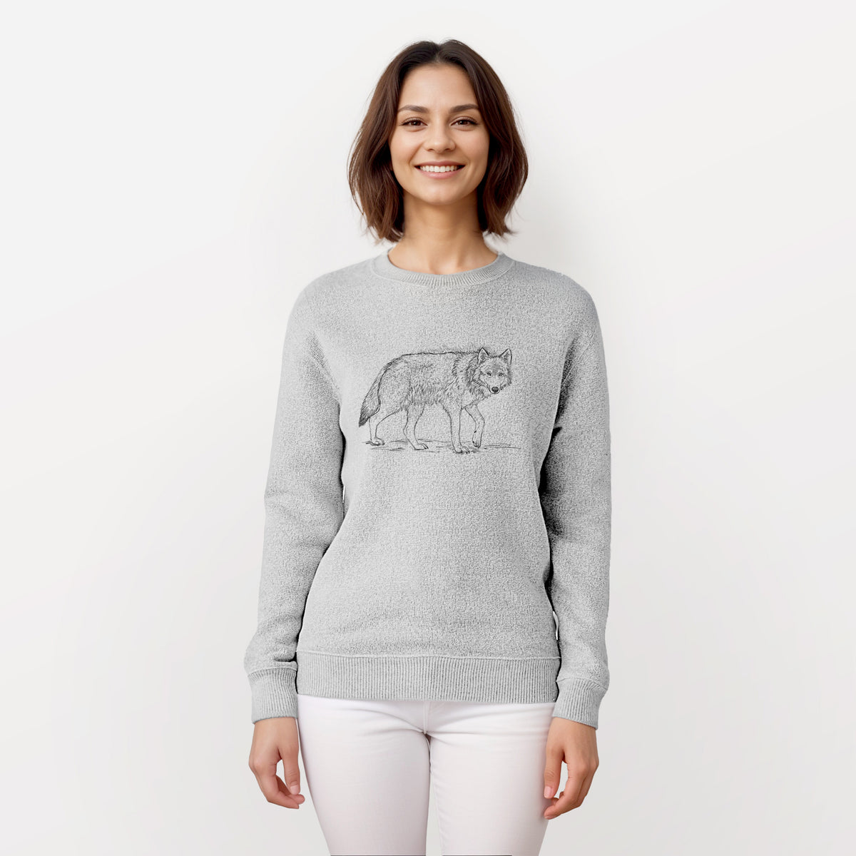 Woman wearing a knit sweatshirt printed with a detailed black ink illustration of a grey wolf walking.