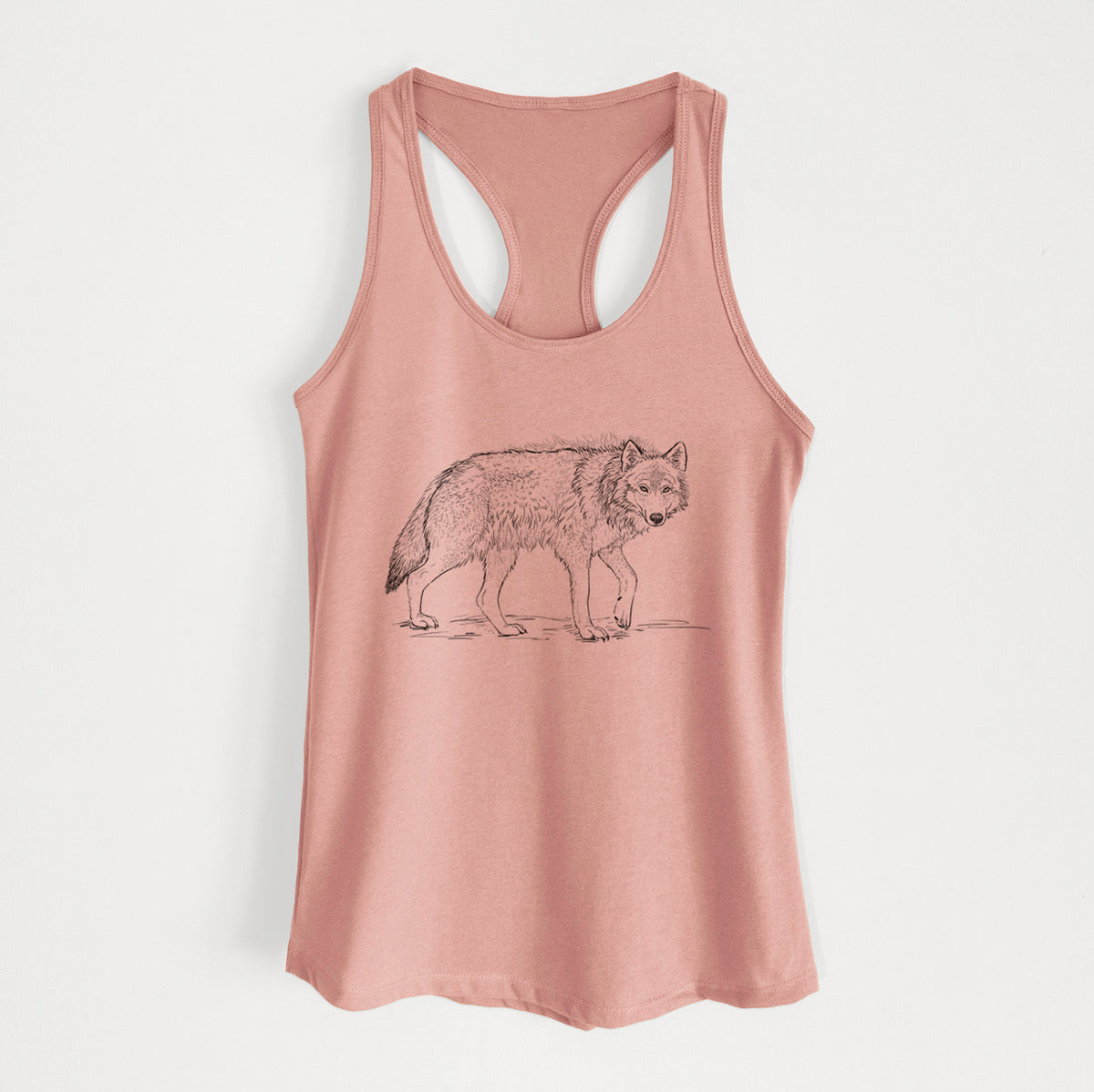 Desert pink women's racerback tank top laid flat, printed with a detailed black ink illustration of a grey wolf walking.