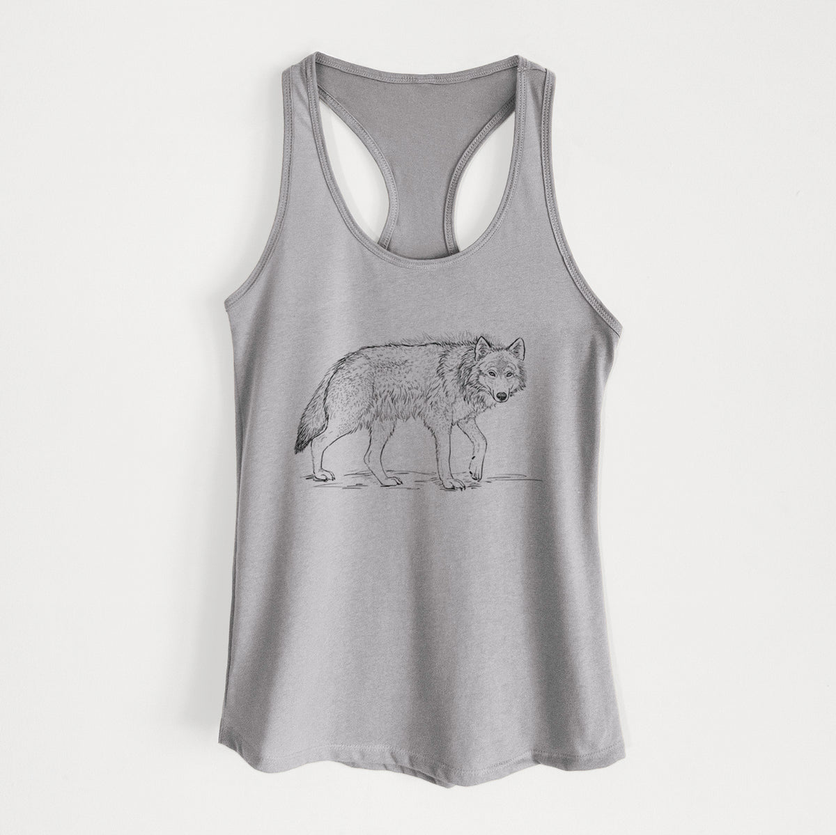 Heather grey women's racerback tank top laid flat, printed with a detailed black ink illustration of a grey wolf walking.