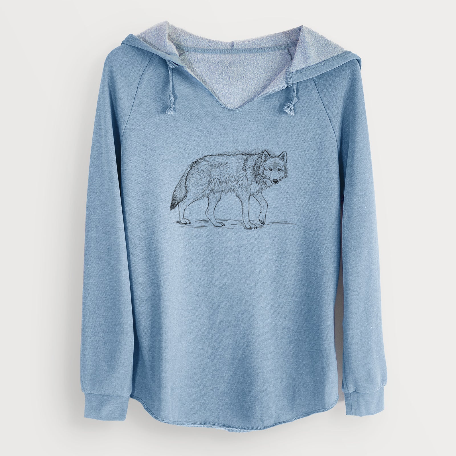 Misty blue women's Cali Wave hooded sweatshirt laid flat, printed with a detailed black ink illustration of a grey wolf walking.