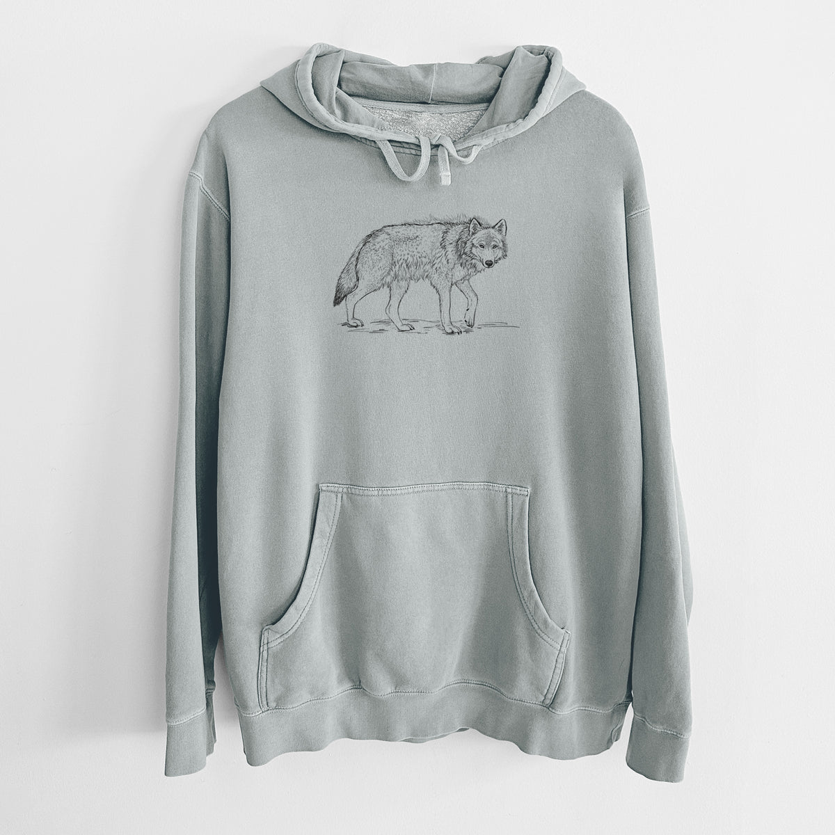 Sage green pigment dyed hoodie laid flat, printed with a detailed black ink illustration of a grey wolf walking.