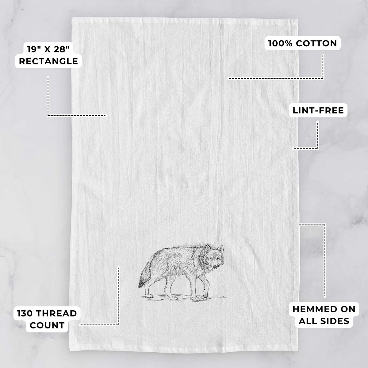 White tea towel printed with a detailed black ink illustration of a grey wolf walking, with feature labels: 19 by 28 inch rectangle, 100% cotton, lint-free, 130 thread count, hemmed on all sides.