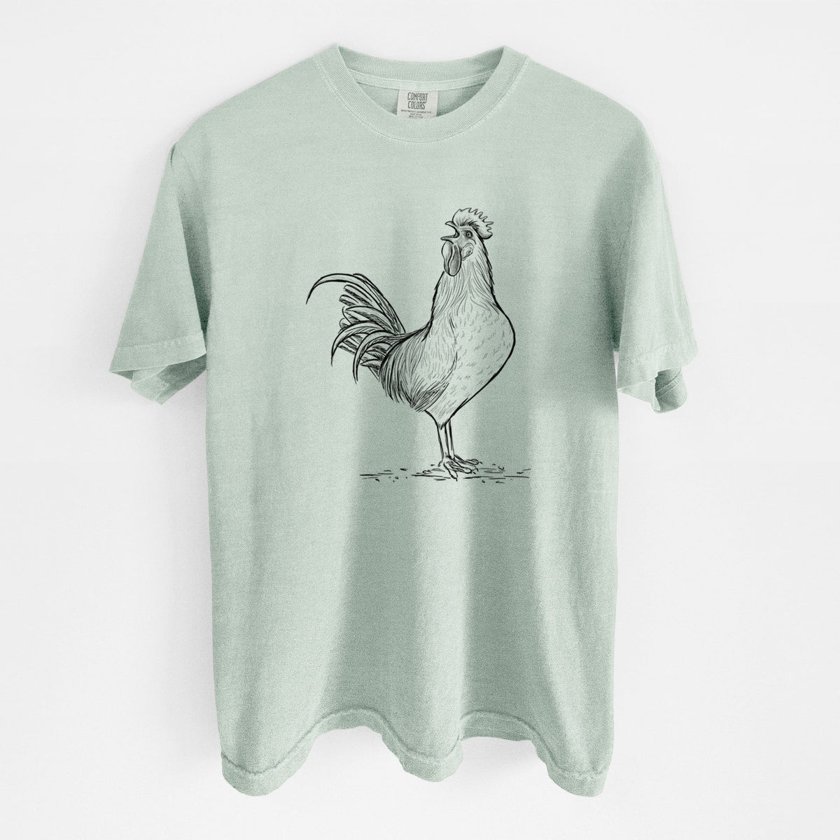 Bay green Comfort Colors t-shirt laid flat, printed with a detailed black ink illustration of a rooster crowing.