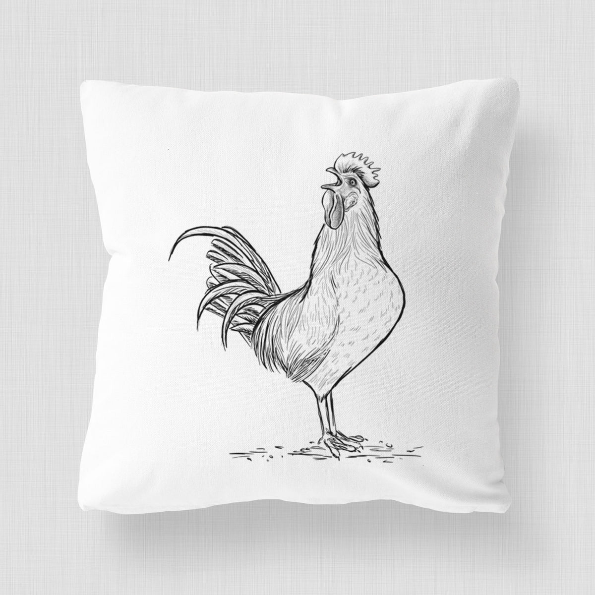 White pillow cover printed with a detailed black ink illustration of a rooster crowing.