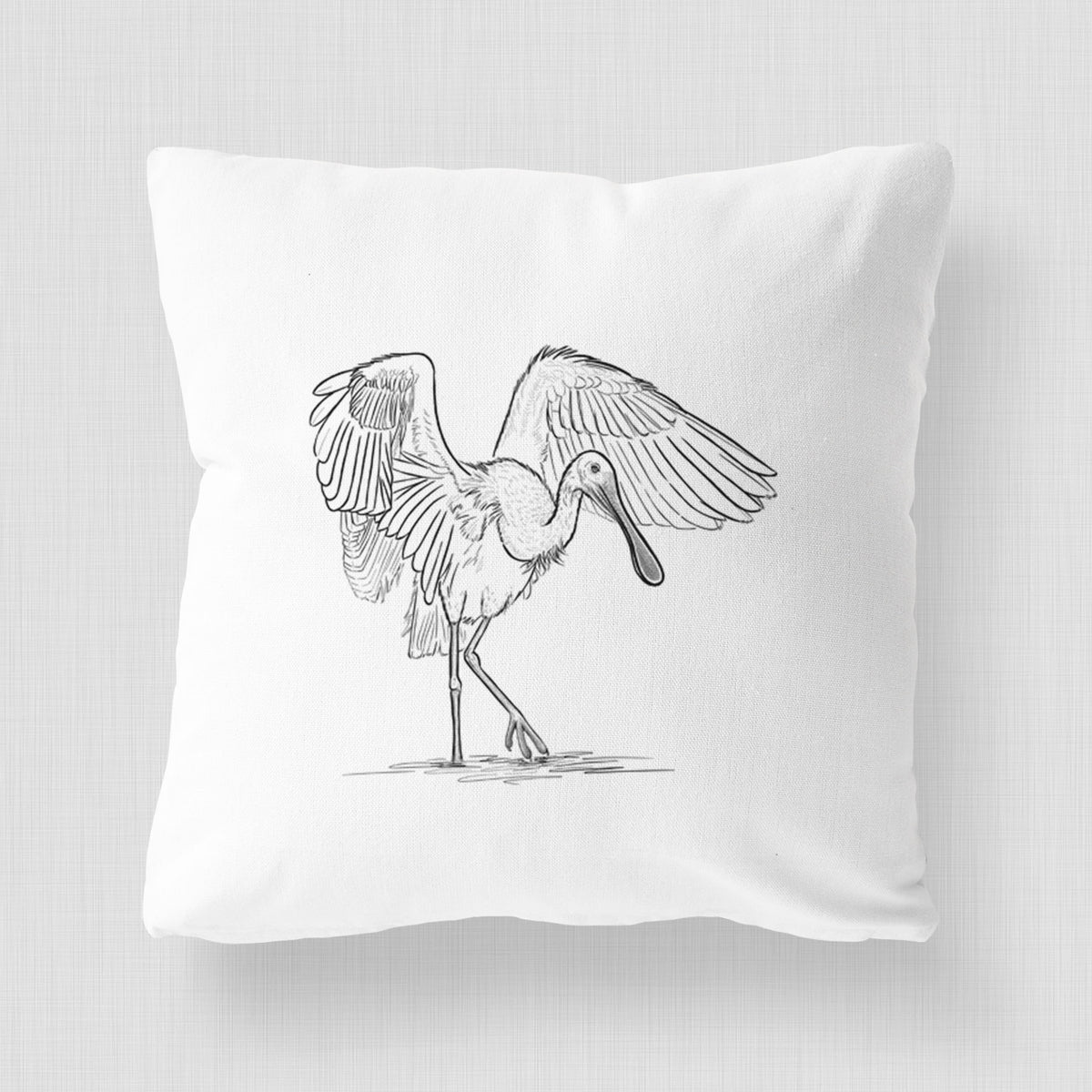 White pillow cover printed with a black ink illustration of a roseate spoonbill standing with its wings spread.