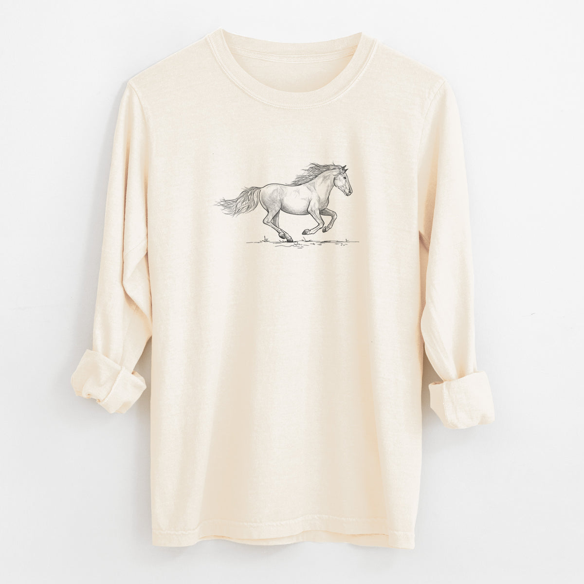 Ivory Comfort Colors long sleeve shirt laid flat with the cuffs rolled, printed with a black ink illustration of a mustang horse running.
