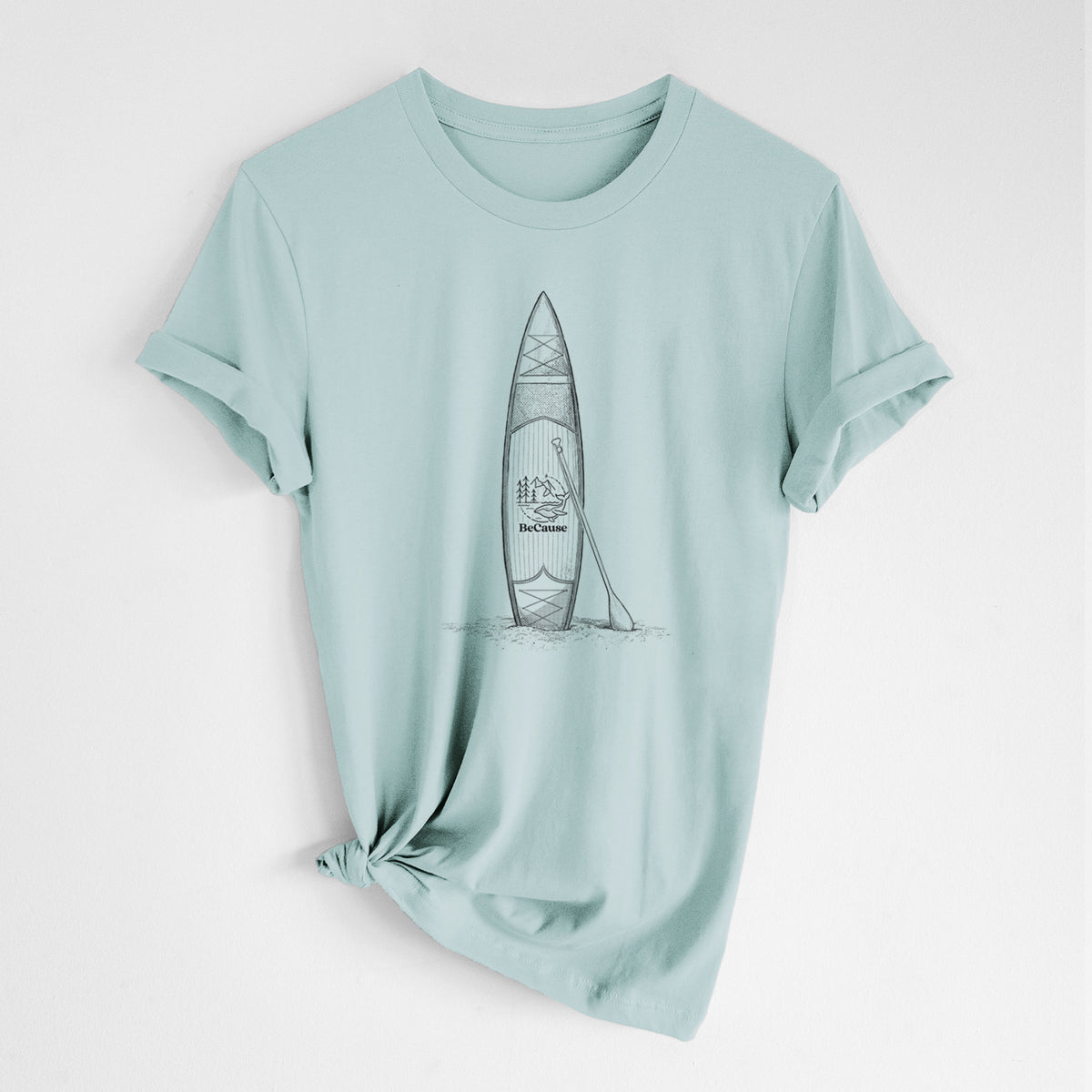 Dusty blue lightweight cotton t-shirt laid flat with the sleeves rolled, printed with a black ink illustration of a stand-up paddleboard with a paddle.