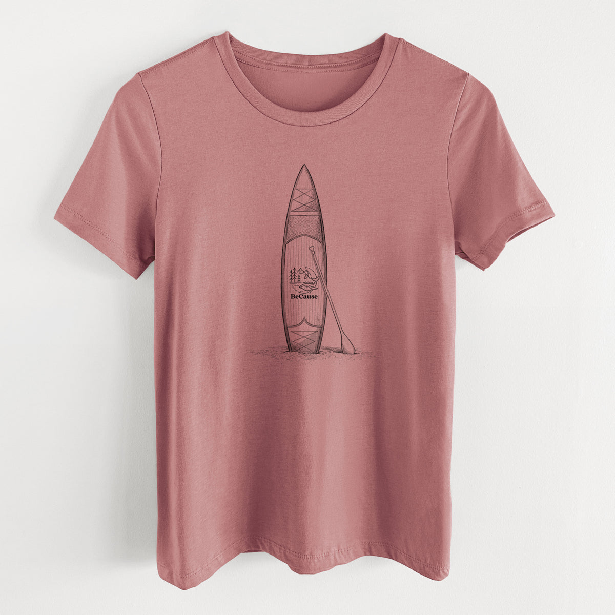 Mauve pink women's relaxed fit cotton t-shirt laid flat, printed with a black ink illustration of a stand-up paddleboard with a paddle.
