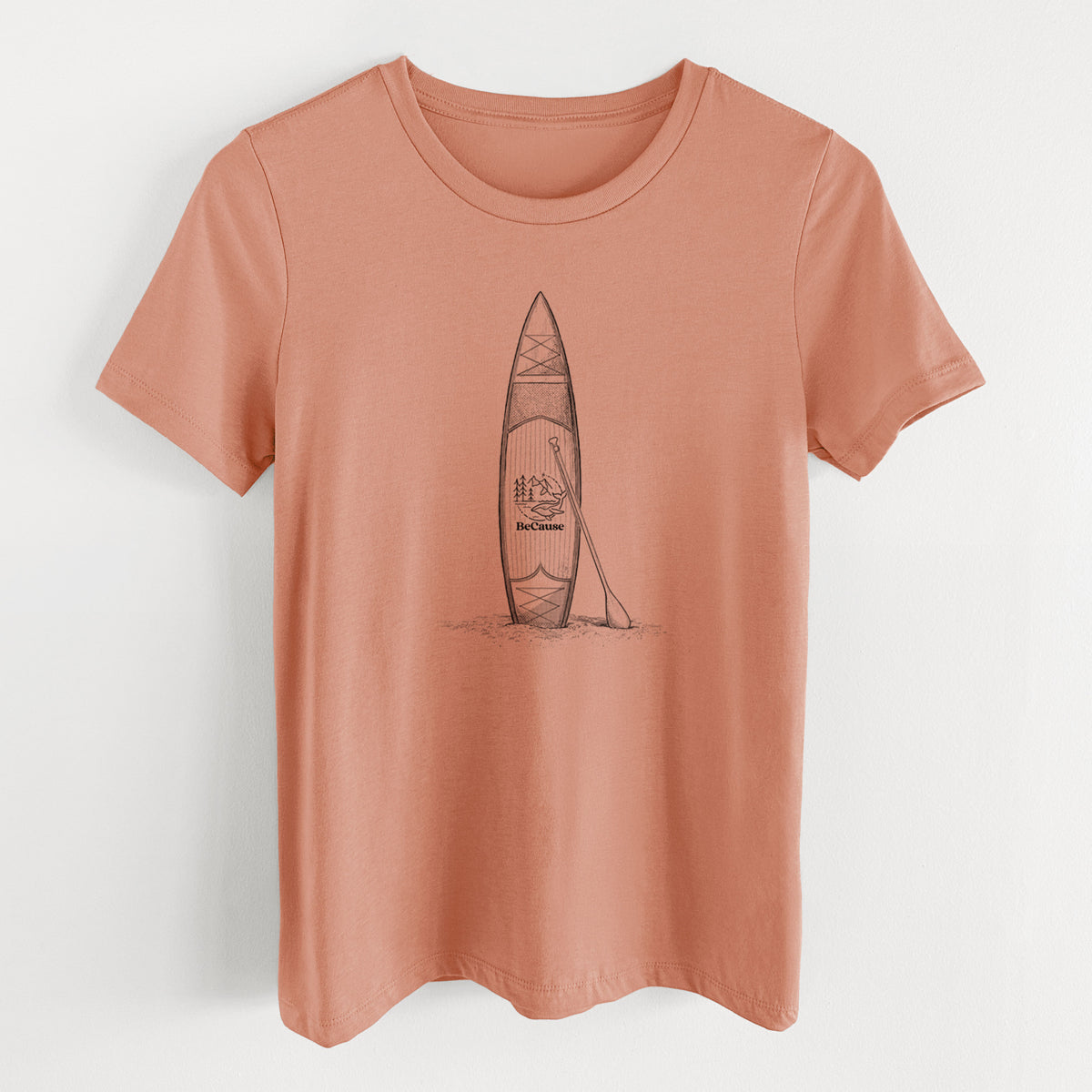 Terracotta orange women's relaxed fit cotton t-shirt laid flat, printed with a black ink illustration of a stand-up paddleboard with a paddle.