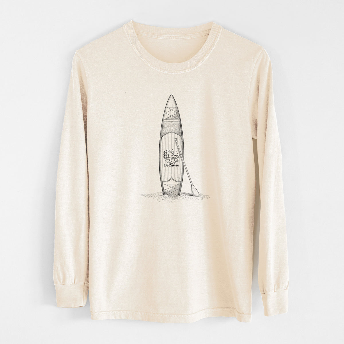 Ivory Comfort Colors long sleeve shirt laid flat, printed with a black ink illustration of a stand-up paddleboard with a paddle.