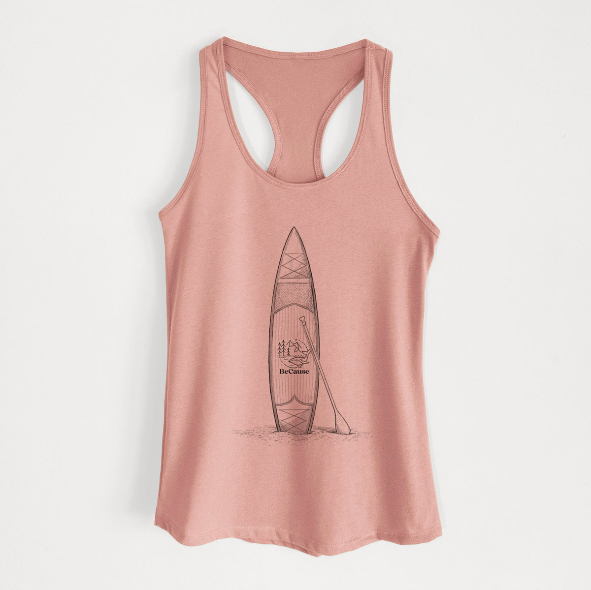 Desert pink women's racerback tank top laid flat, printed with a black ink illustration of a stand-up paddleboard with a paddle.