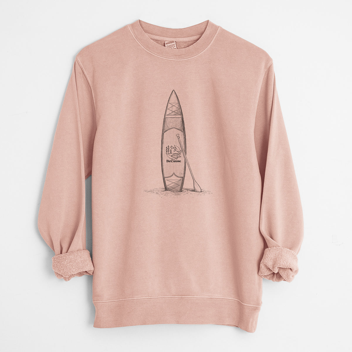 Dusty pink pigment dyed crewneck sweatshirt laid flat with the sleeves rolled, printed with a black ink illustration of a stand-up paddleboard with a paddle.