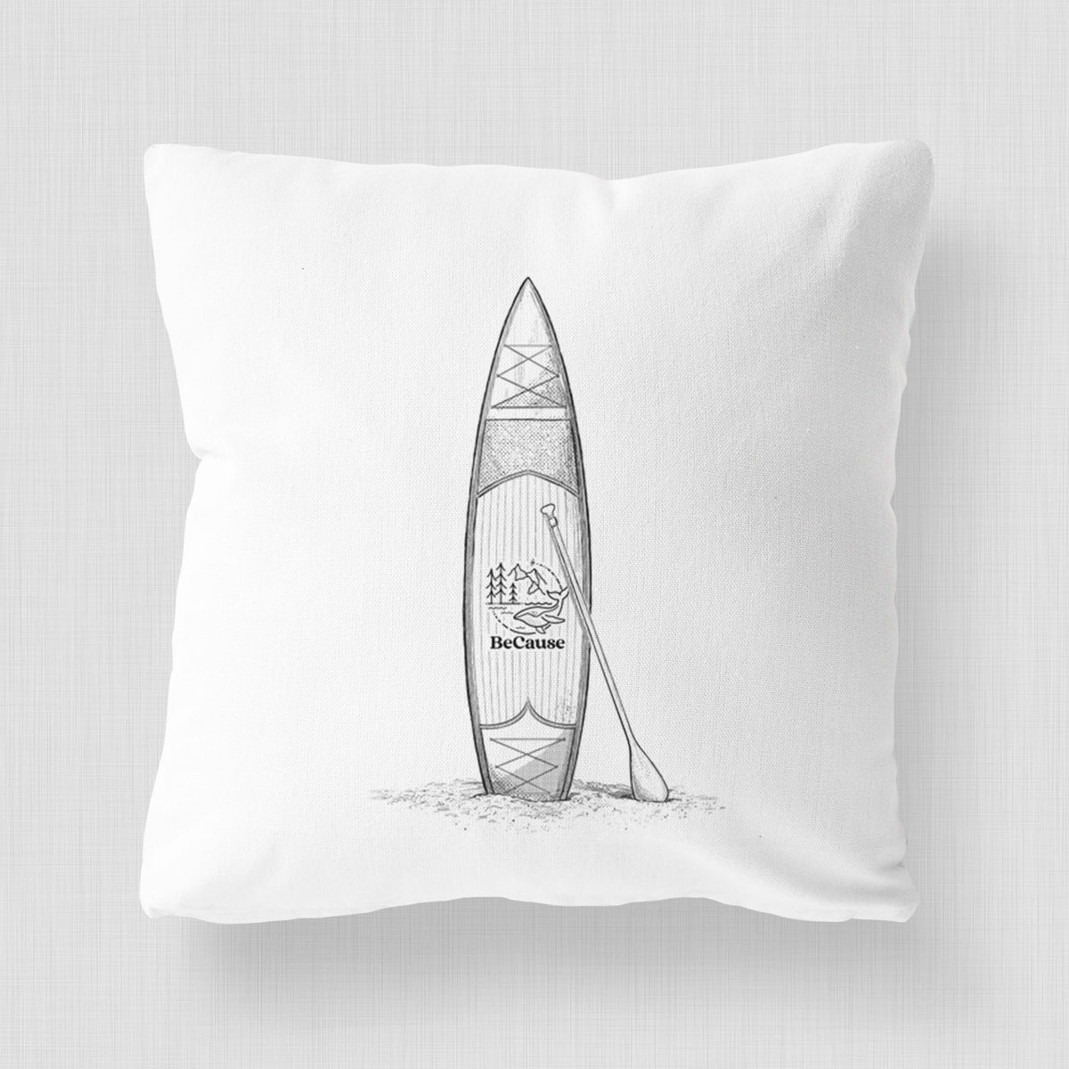 White pillow cover printed with a black ink illustration of a stand-up paddleboard with a paddle.