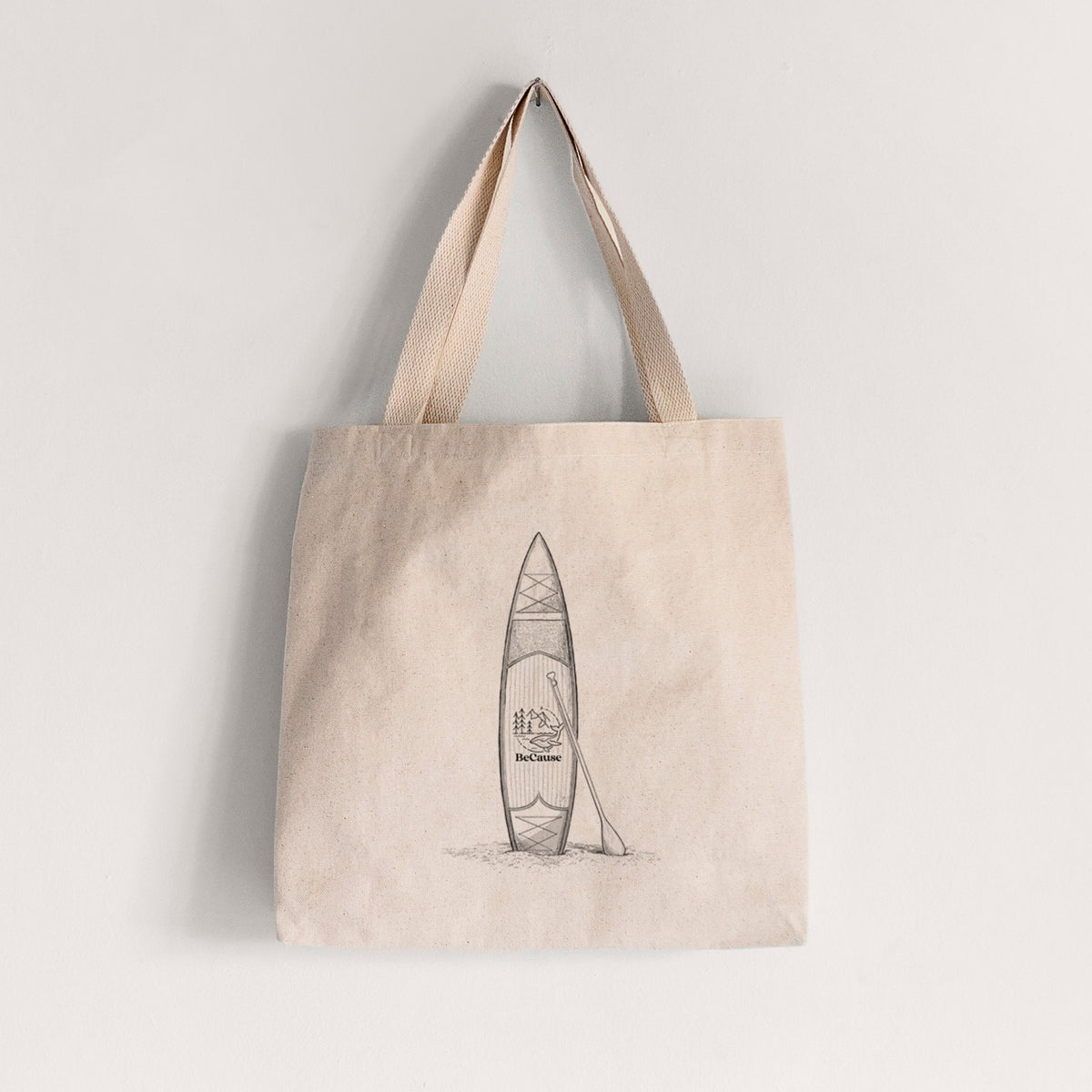 Natural canvas tote bag printed with a black ink illustration of a stand-up paddleboard with a paddle.