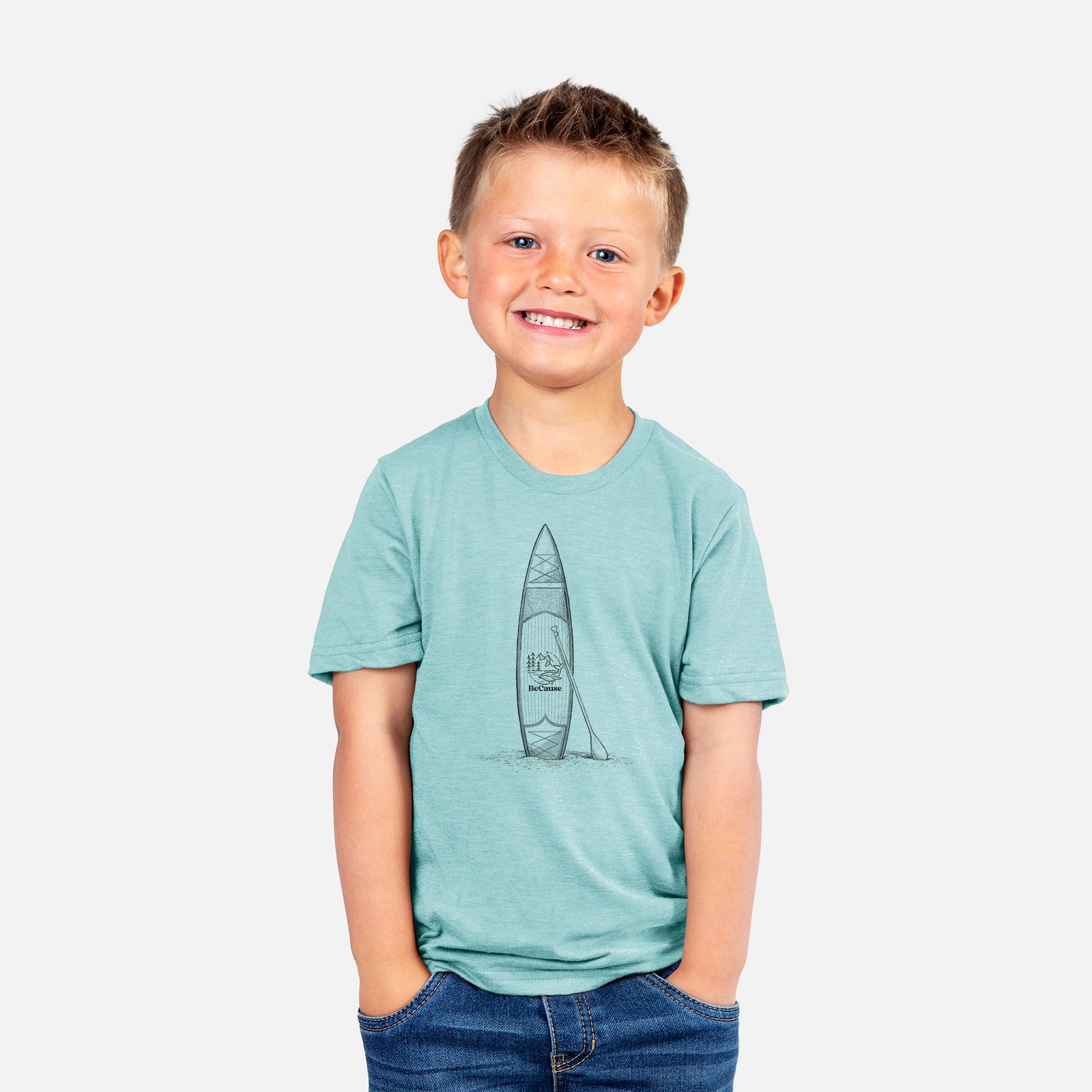 Two youth t-shirts in different colors on hangers, printed with a black ink illustration of a stand-up paddleboard with a paddle.