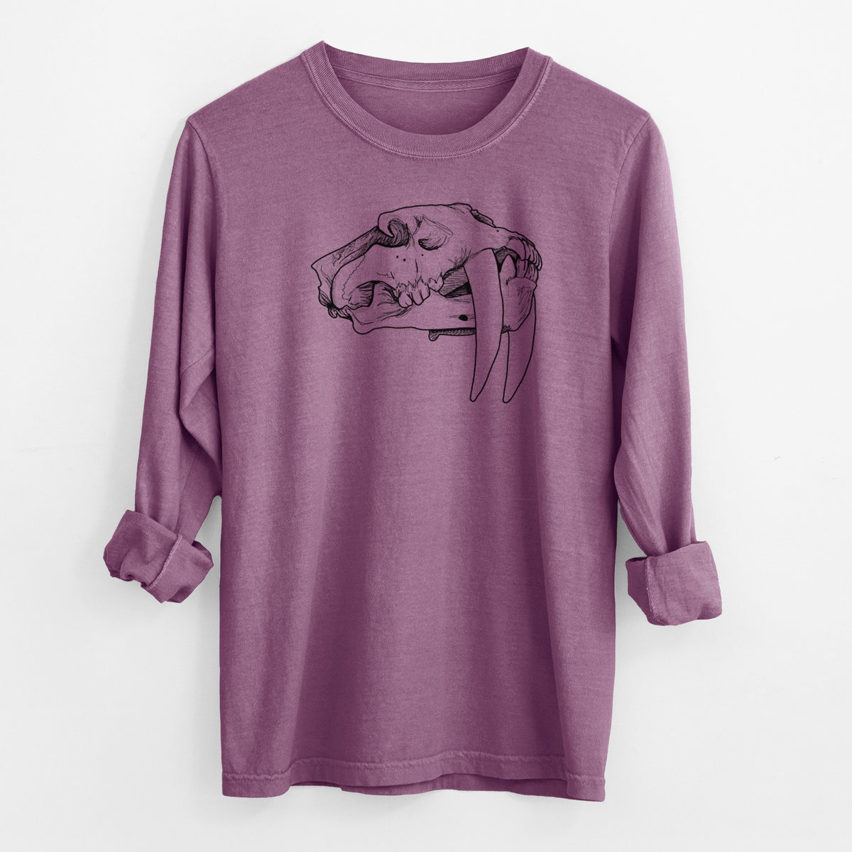 Berry pink Comfort Colors long sleeve shirt laid flat with the cuffs rolled, printed with a detailed black ink illustration of a saber-toothed tiger skull.