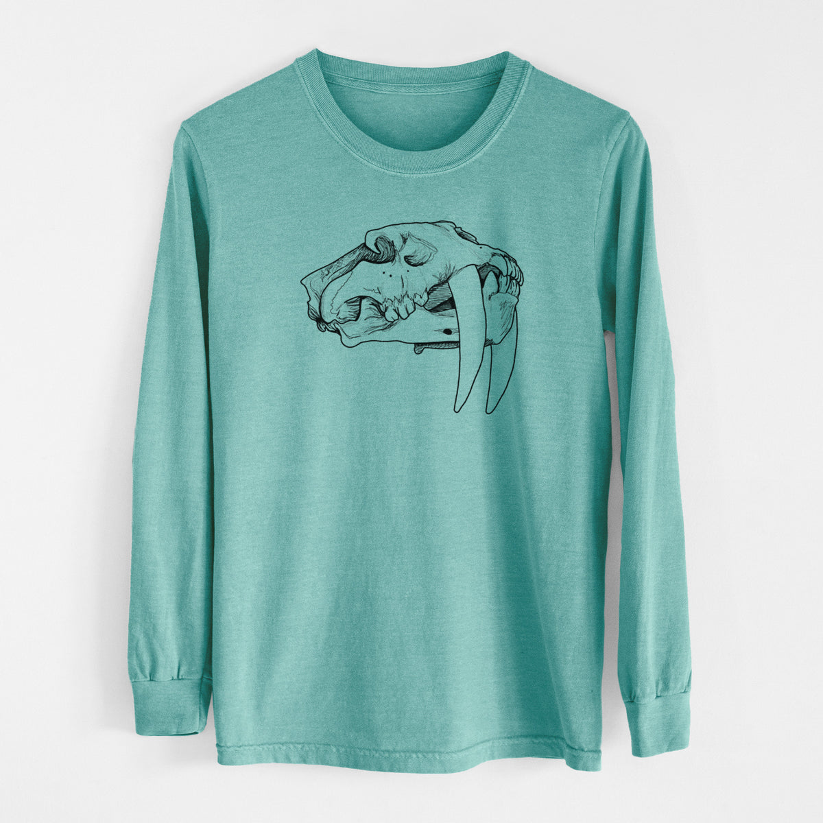 Reef green Comfort Colors long sleeve shirt laid flat, printed with a detailed black ink illustration of a saber-toothed tiger skull.