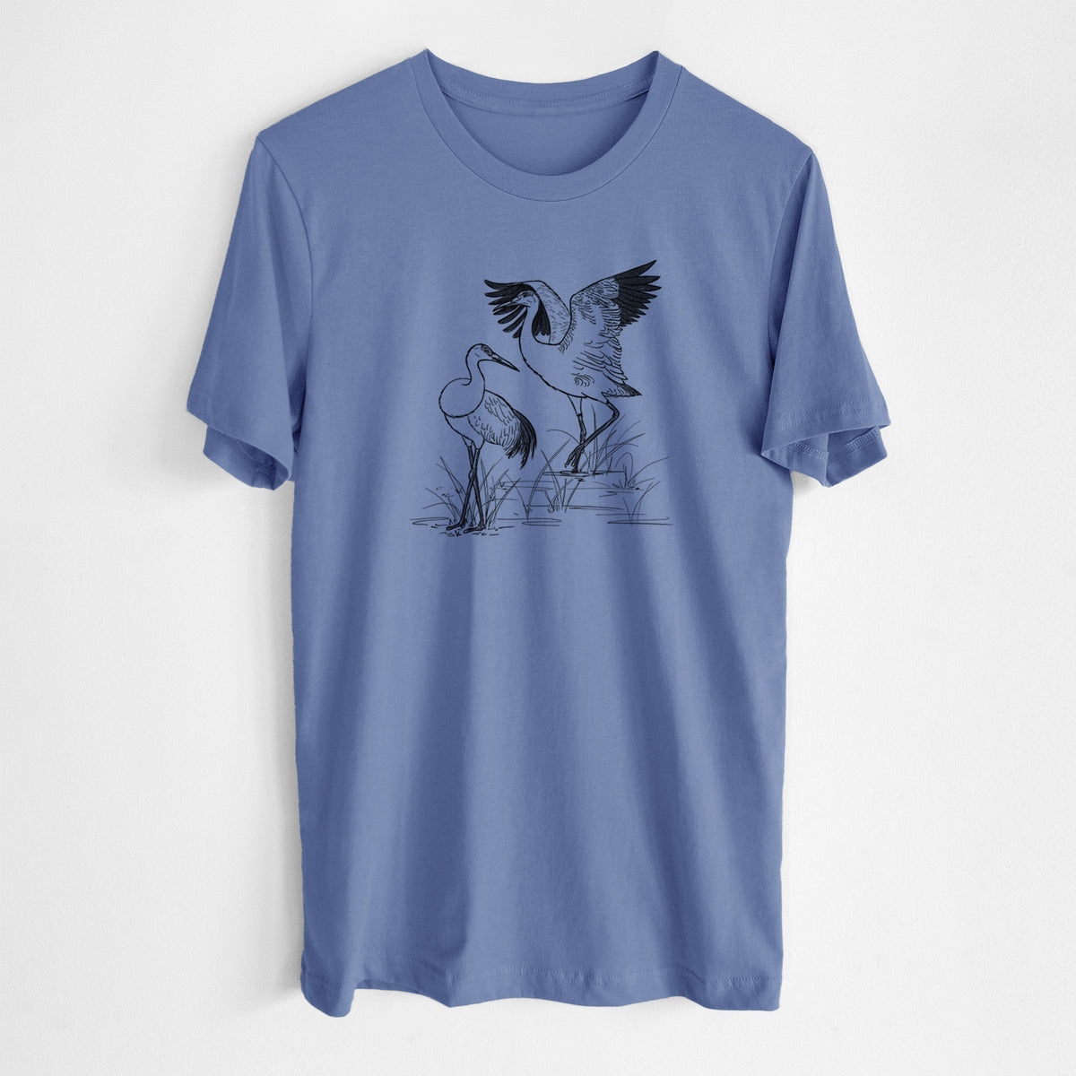 Blue bell lightweight cotton t-shirt laid flat, printed with a black ink illustration of two sandhill cranes in marsh grass, one with its wings raised.