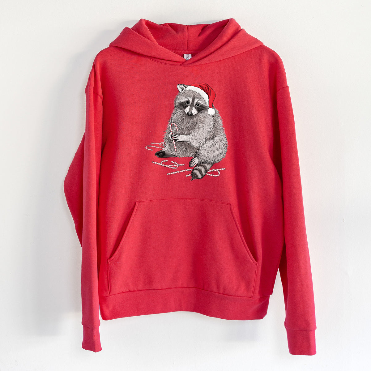 Santa Raccoon - Statement Midweight Hoodie in Cherry Red, hanging on a white wall, with a front kangaroo pocket and no drawcords.