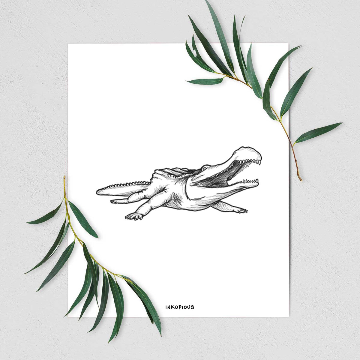 Art print of a black ink illustration of a Sarcosuchus, a giant prehistoric crocodile, shown with eucalyptus leaves.