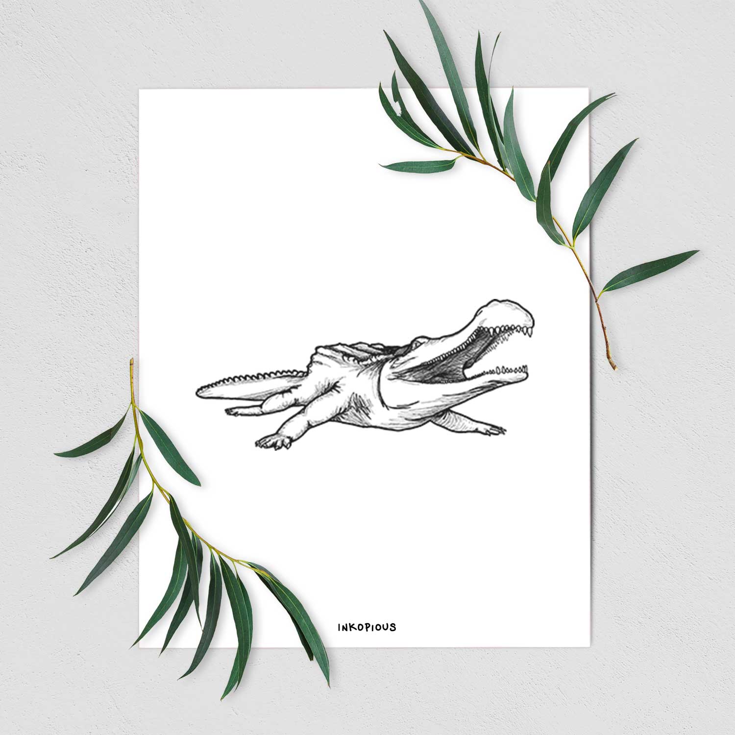 Art print of a black ink illustration of a Sarcosuchus, a giant prehistoric crocodile, shown with eucalyptus leaves.