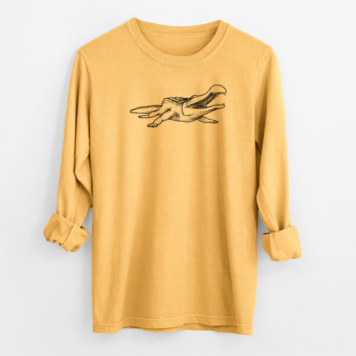 Golden wheat yellow Comfort Colors long sleeve shirt laid flat with the cuffs rolled, printed with a black ink illustration of a Sarcosuchus, a giant prehistoric crocodile.
