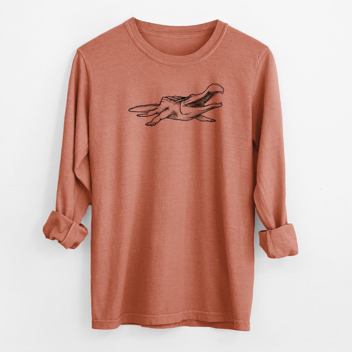 Yam burnt orange Comfort Colors long sleeve shirt laid flat with the cuffs rolled, printed with a black ink illustration of a Sarcosuchus, a giant prehistoric crocodile.