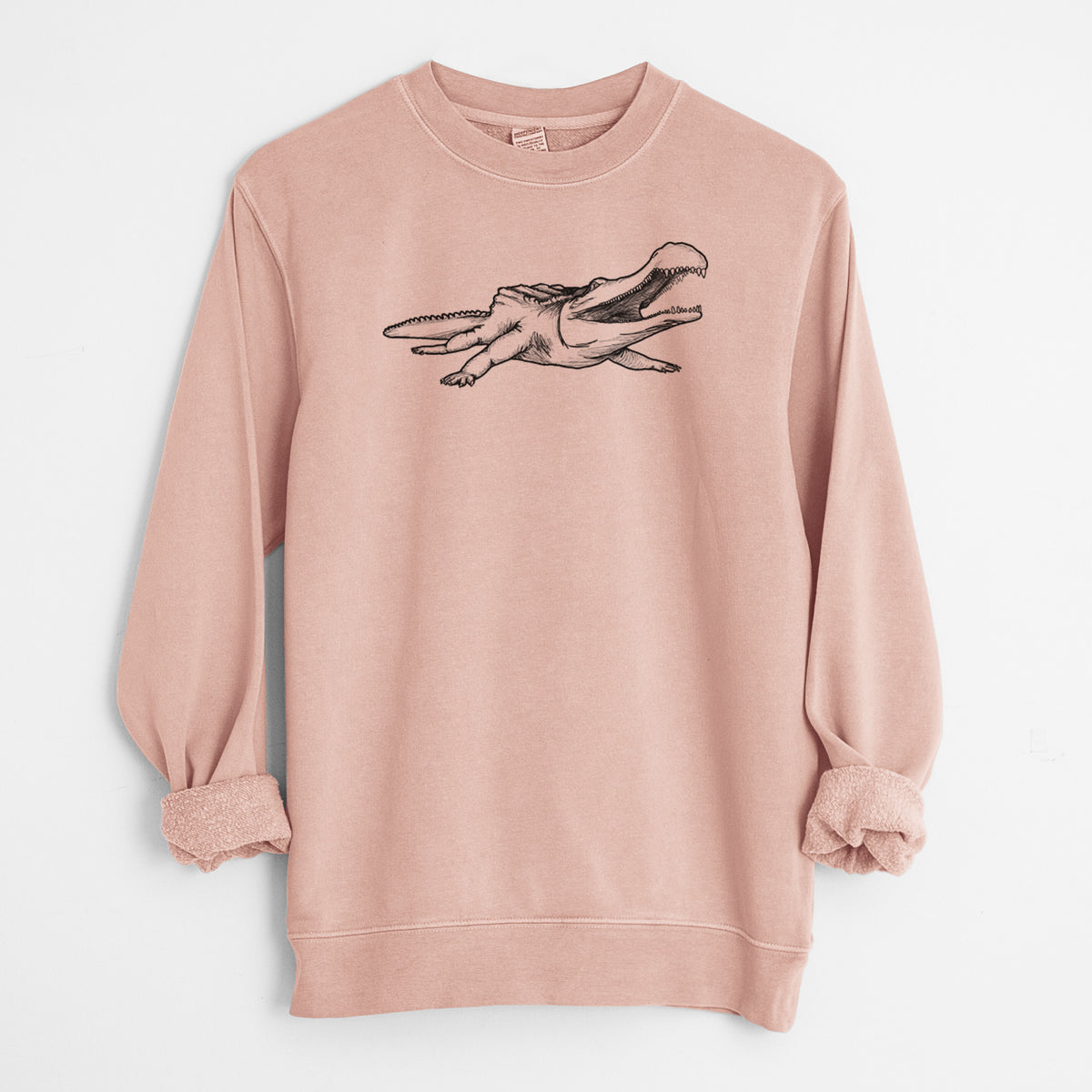 Dusty pink pigment dyed crewneck sweatshirt laid flat with the sleeves rolled, printed with a black ink illustration of a Sarcosuchus, a giant prehistoric crocodile.