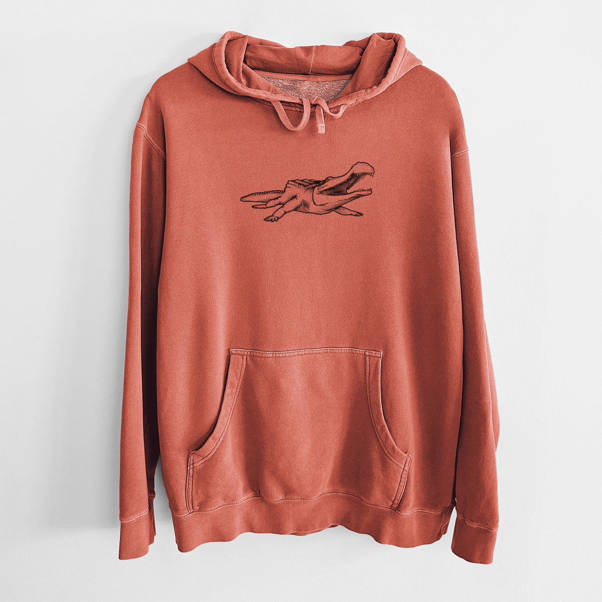Amber orange pigment dyed hoodie laid flat, printed with a black ink illustration of a Sarcosuchus, a giant prehistoric crocodile.