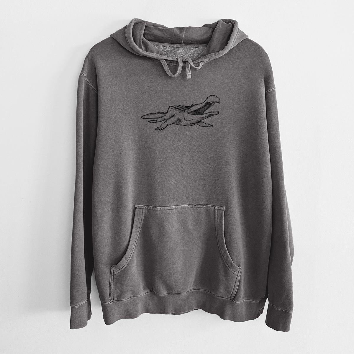 Faded black pigment dyed hoodie laid flat, printed with a black ink illustration of a Sarcosuchus, a giant prehistoric crocodile.