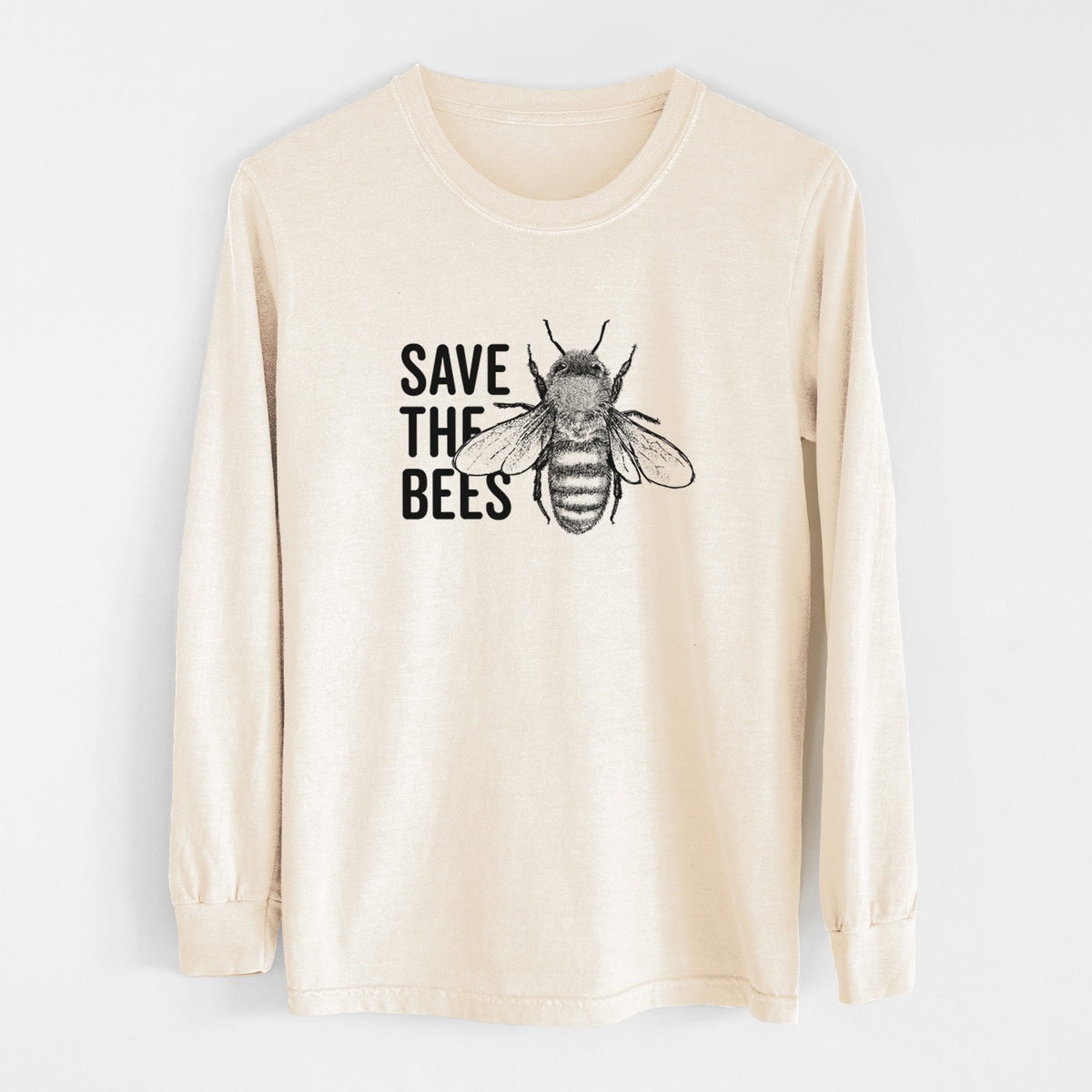 Ivory Comfort Colors long sleeve shirt laid flat, printed with bold black words reading Save the Bees beside a detailed honey bee illustration.