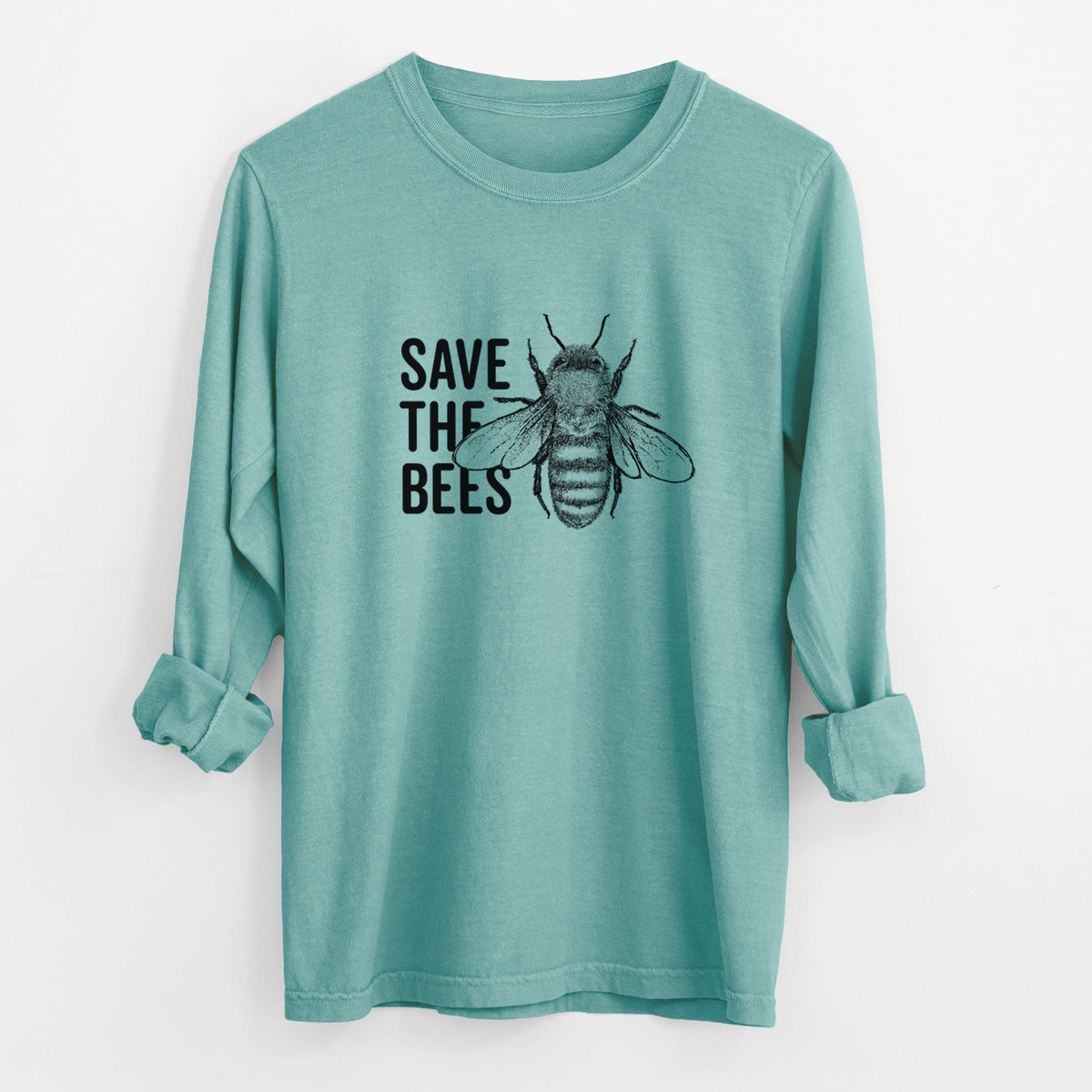 Reef green Comfort Colors long sleeve shirt laid flat with the cuffs rolled, printed with bold black words reading Save the Bees beside a detailed honey bee illustration.
