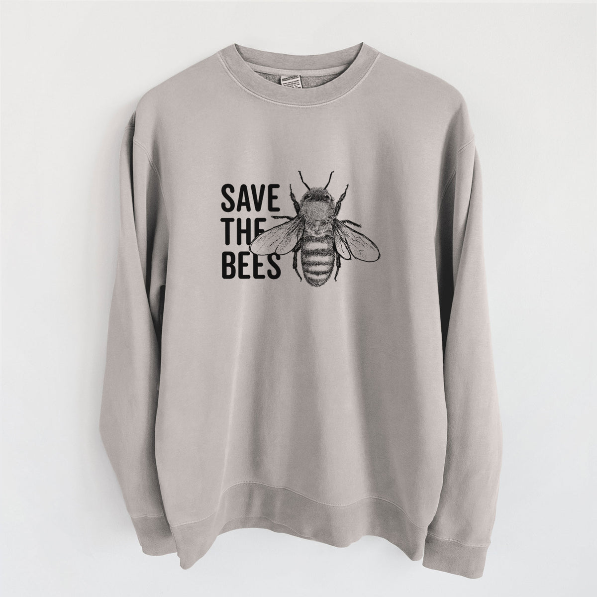 Cement grey pigment dyed crewneck sweatshirt laid flat, printed with bold black words reading Save the Bees beside a detailed honey bee illustration.