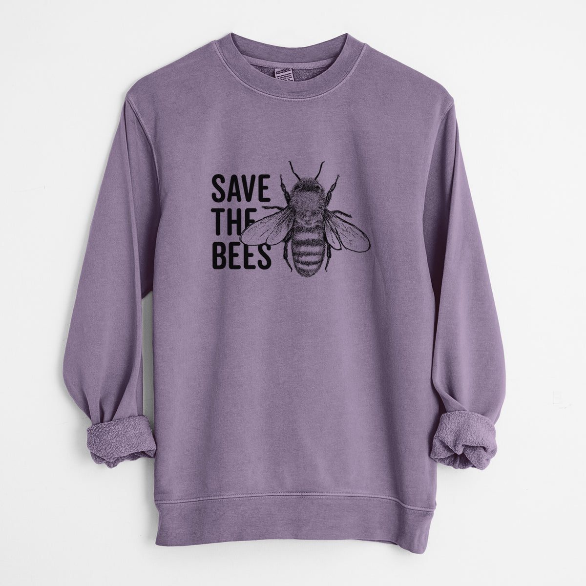 Plum purple pigment dyed crewneck sweatshirt laid flat with the sleeves rolled, printed with bold black words reading Save the Bees beside a detailed honey bee illustration.