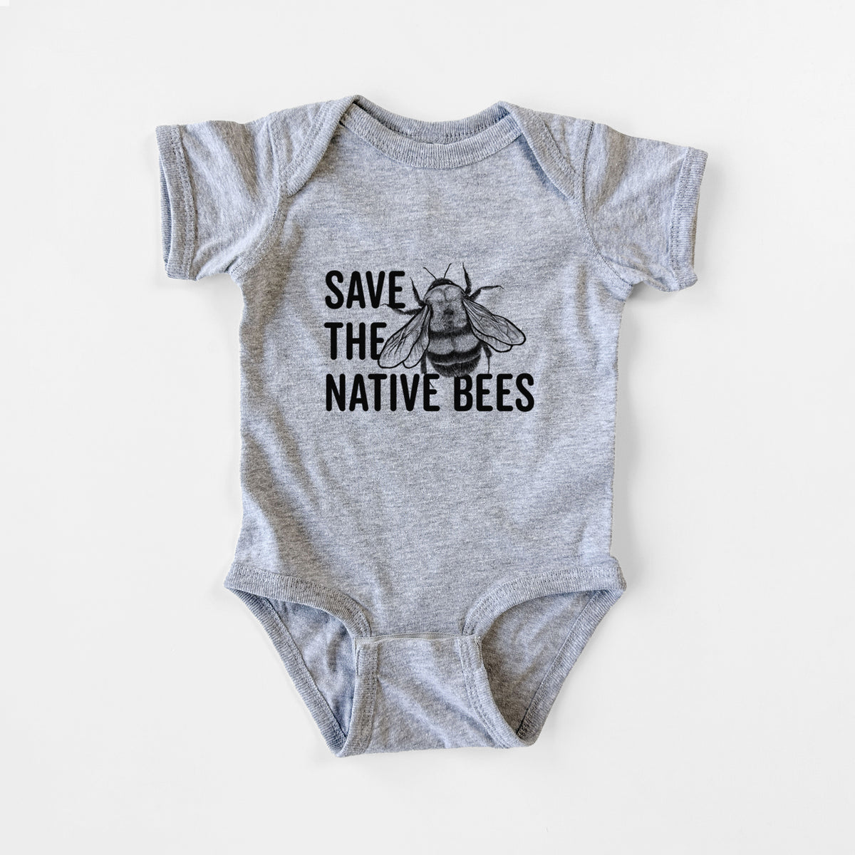 Grey baby bodysuit laid flat, printed with bold black words reading Save the Native Bees beside a detailed bee illustration.