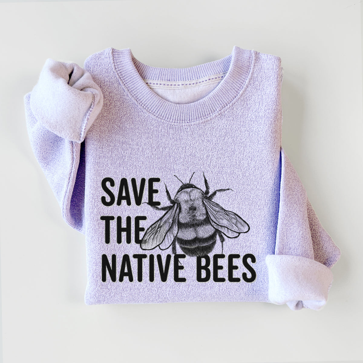 Ice purple knit sweatshirt printed with bold black words reading Save the Native Bees beside a detailed bee illustration, styled flat.